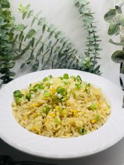 Egg Fried Rice features fried rice mixed with scrambled eggs, garnished with scallions, all coated in a savory sauce at JCK Asia Kitchen & Bar, a Asian Cuisine restaurant in Chula Vista