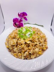 Special Fried Rice features a flavorful fried rice dish with eggs, garnished with scallions and an orchid flower at JCK Asia Kitchen & Bar, a Asian Cuisine restaurant in Chula Vista