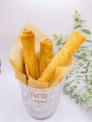 Egg Rolls features crispy, deep - fried rolls filled with ingredients, wrapped in parchment paper at JCK Asia Kitchen & Bar, a Asian Cuisine restaurant in Chula Vista